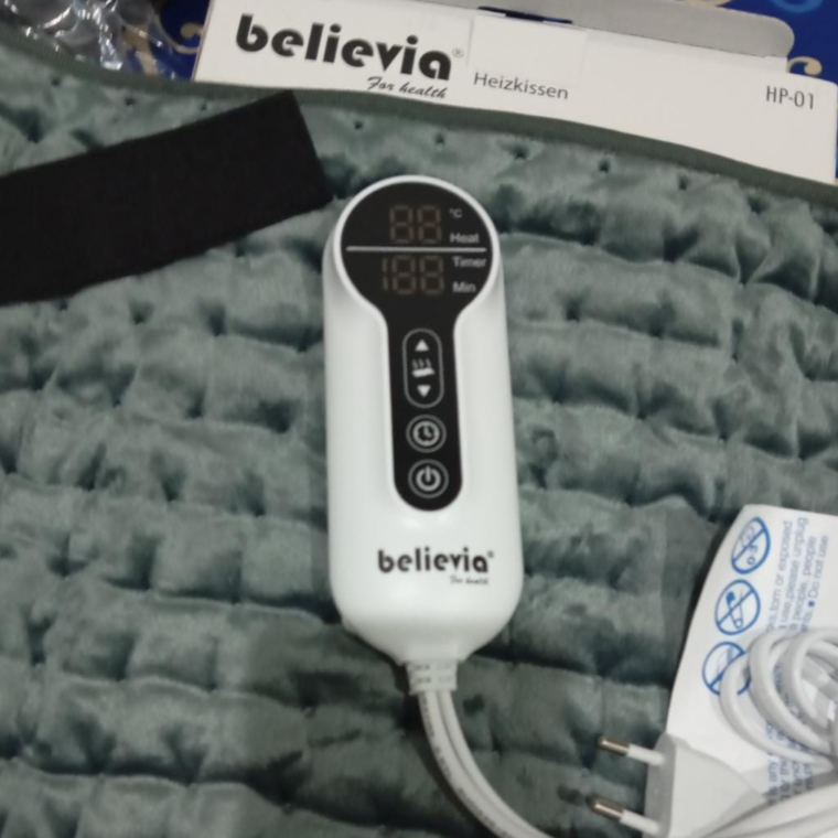 Close-up of Believia HP-01 heating pad fabric and controller
